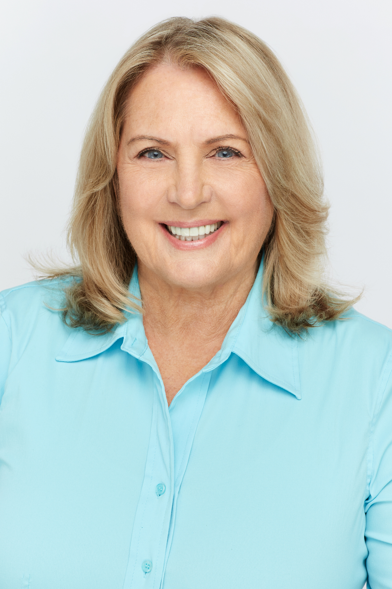 Cookie Colletti professional actor headshot in blue shirt
