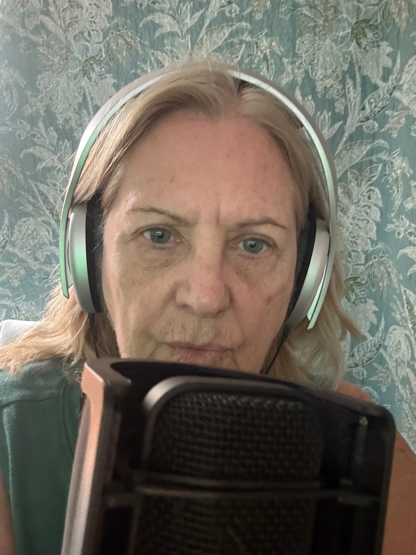 Cookie Colletti recording voice over with microphone and headphones